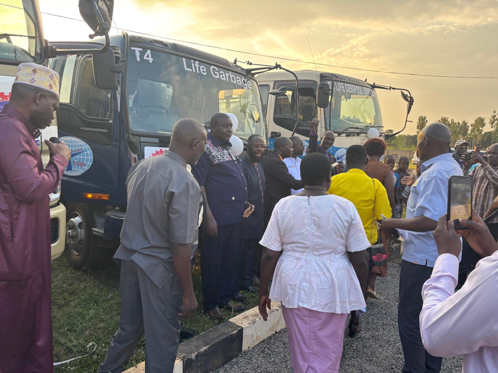 Attendees and community members gathering around the trucks during the launch